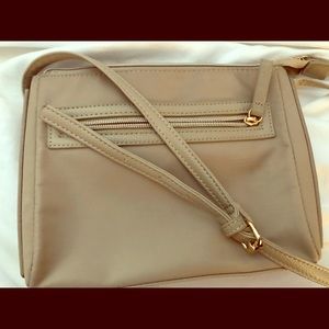 Cross body purse with pocket and zipper.